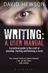 Book cover for Writing: A User Manual by David Hewson, a black cover with a brown eye close-up along the top
